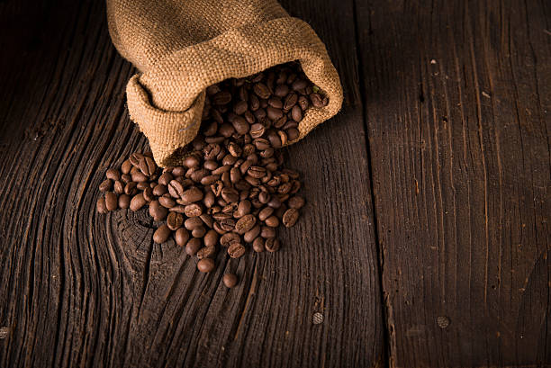istock Cup of coffee, bag and scoop on old rusty background 614346552