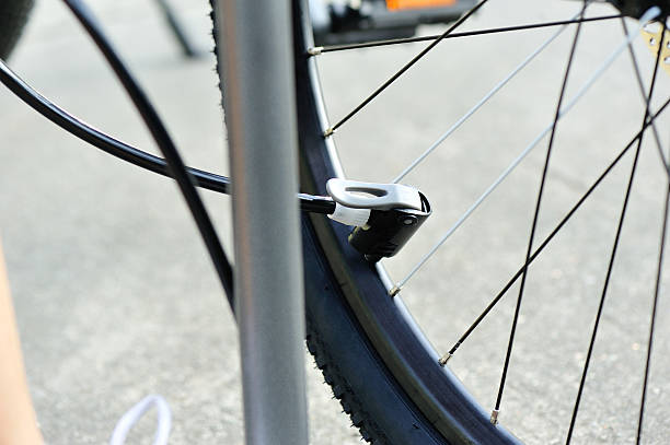 istock pumping air into the wheel of bycle. 614347692