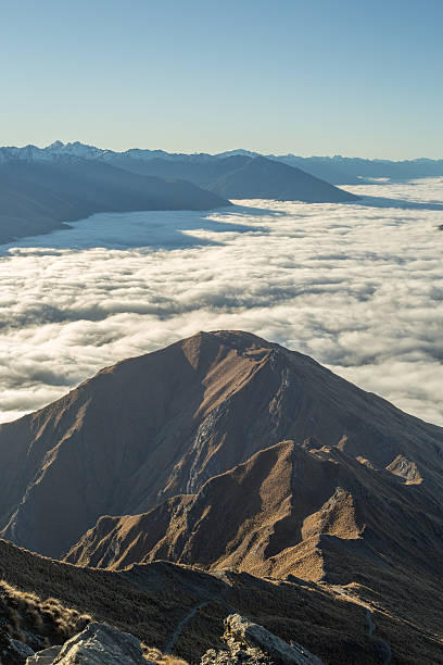 istock Aerial view of mountains above clouds 614348164
