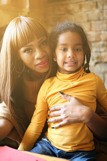 istock African mother huging her daughter. 614348450