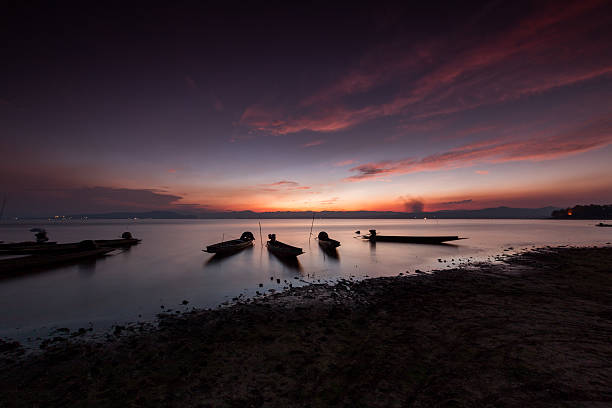 istock fisherman boat and beautiful twilight in thailand. 614348838