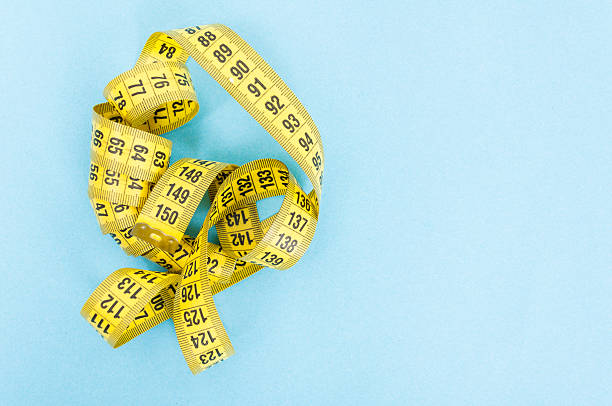 istock Weight loss concept with yellow centimeter 614349716