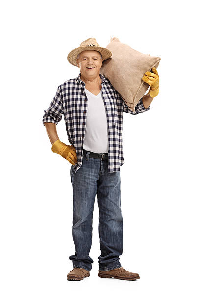 istock Mature farmer holding a burlap sack 614350376