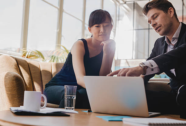 Business partners working together on laptop in office