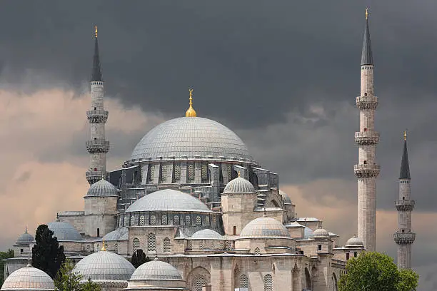 Suleymaniye Mosque in Istanbul with dark clouds in the background.