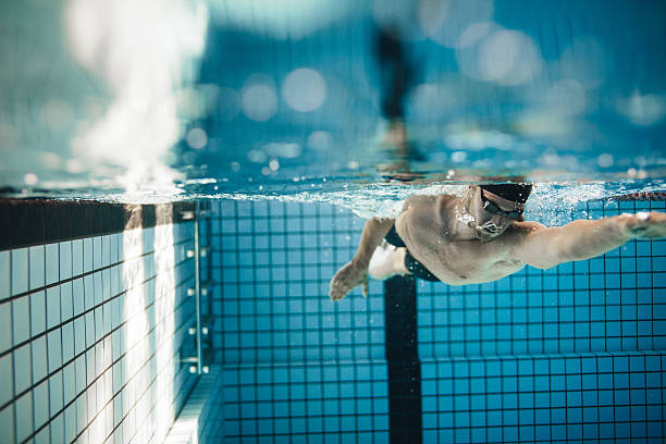 istock Fit young male swimmer training in the pool 614403878