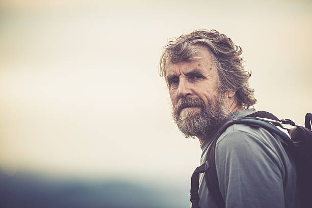 Senior man with beard  - Mountaineer outdoors, Slovenia, Europe. Granulated. All logos removed. Nikon D800, full frame, Nikkor 70.0-200.0 mm, aperture 2.8, Copy space.