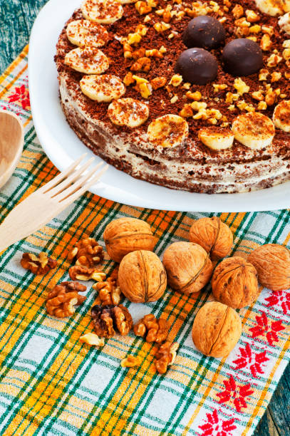 istock Chocolate cake with nuts and bananas on a plate 614404234