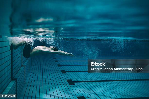 Male Swimmer Turning Over In Swimming Pool Stock Photo - Download Image Now - Swimming, Sport, Swimming Pool