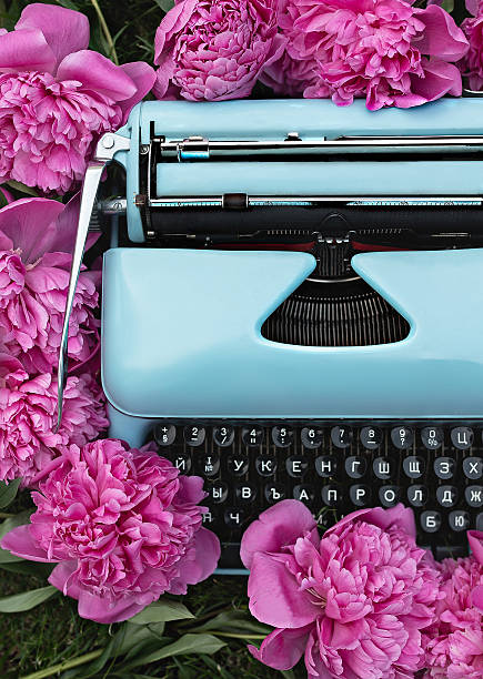 istock Romantic blue typewriter and pink flowers 614404630