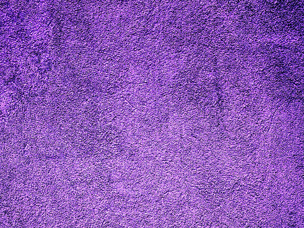 istock An old concrete wall painted in purple. 614405030