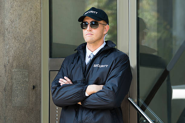 istock Male Security Guard Standing At The Entrance 614405542