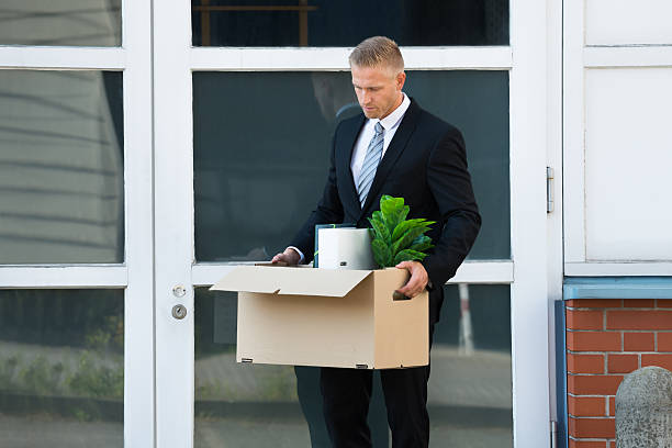 istock Businessman Carrying His Belongings In Box After Being Fired 614405580