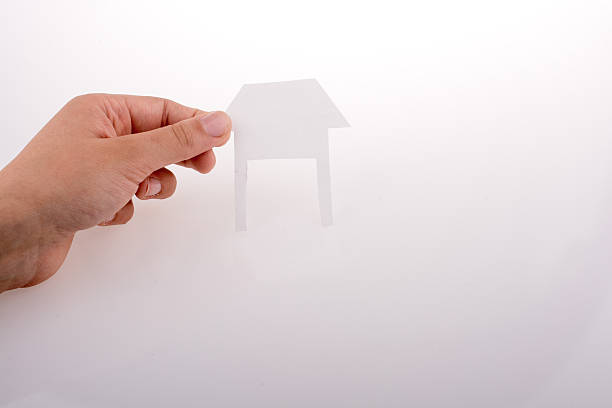 istock Hand holding a paper house 614407048