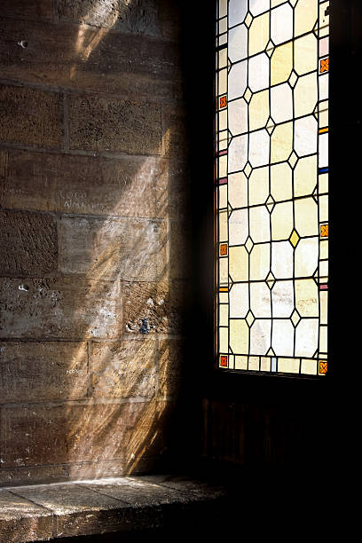 istock sunshine through colorful glass window 614408754