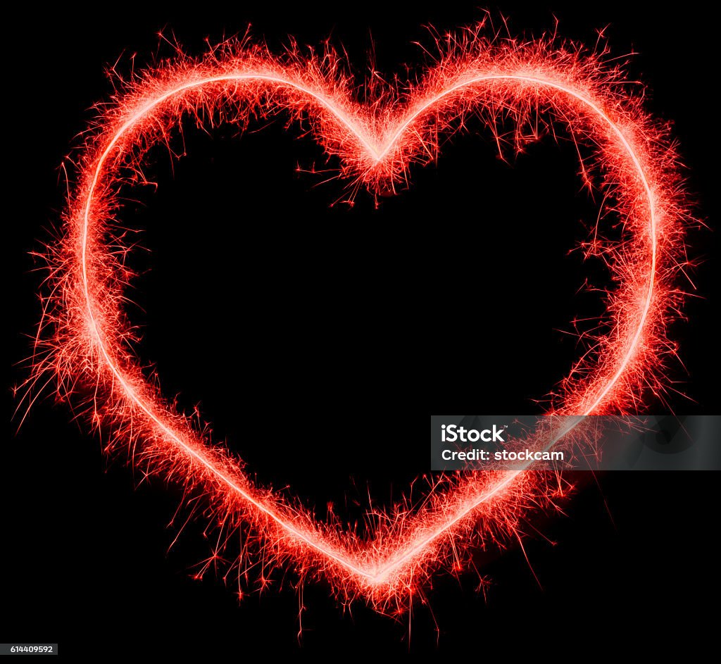 Red sparklers glowing heart on black Long exposure of red sparklers making the shape of a heart Heart Shape Stock Photo