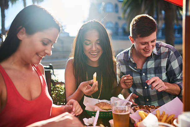istock friends eating at outdoor restaurant 614409716