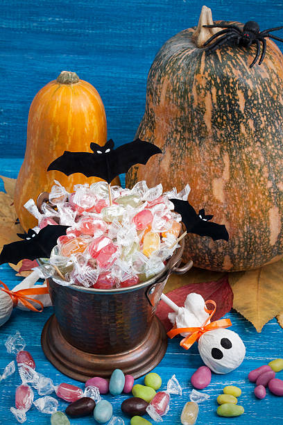 istock Halloween composition with pumpkins, candy bucket, paper bats, rubber spider 614410804