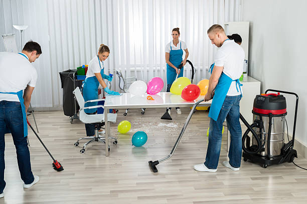 istock Janitors Cleaning The Office After Party 614411760
