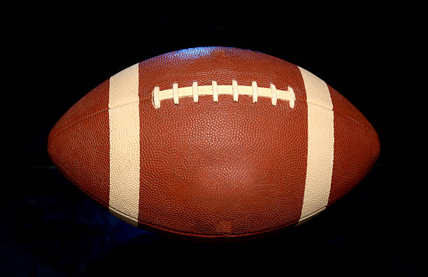 istock American Football close up on black background 614412366