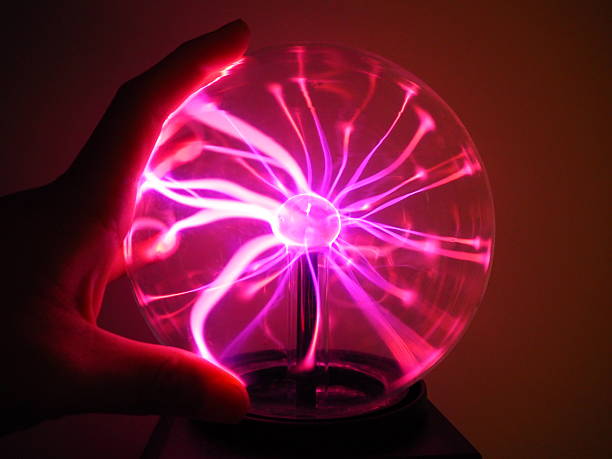 istock Purple pink Plasma filaments plasma globe ball with hand touching 614414398