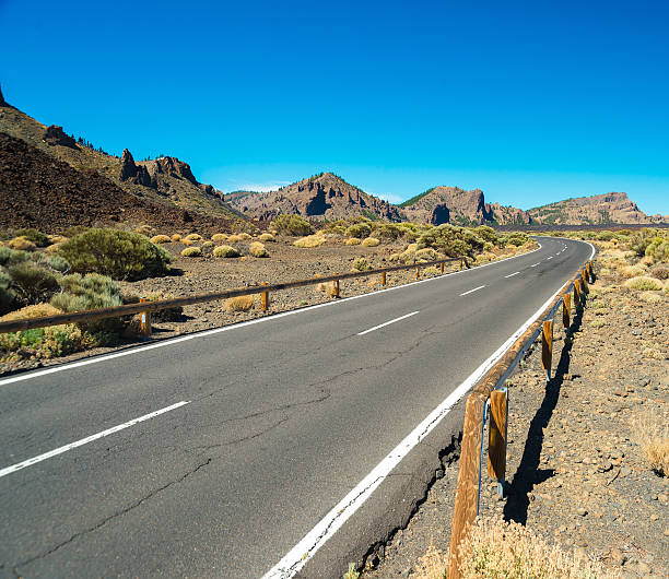 istock Asphalt road  through the desert in rocky mountains 614415120