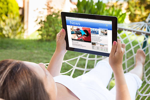 istock Woman On Hammock Reading News 614415160