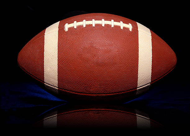 istock American Football close up with reflection on black background 614415334
