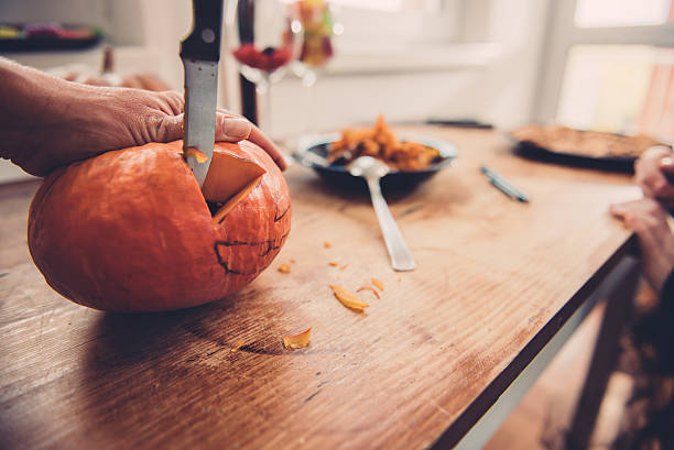 istock Daughter and mother creating Jack-O-Lantern 614417472