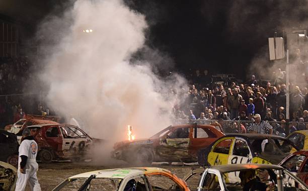 demolition  derby Hamilton, ON Canada – September 24, 2016: car pileup with fire and smoke during the demolition derby  at night at  the Ancaster Fair, Hamilton Ontario Canada  pileup stock pictures, royalty-free photos & images