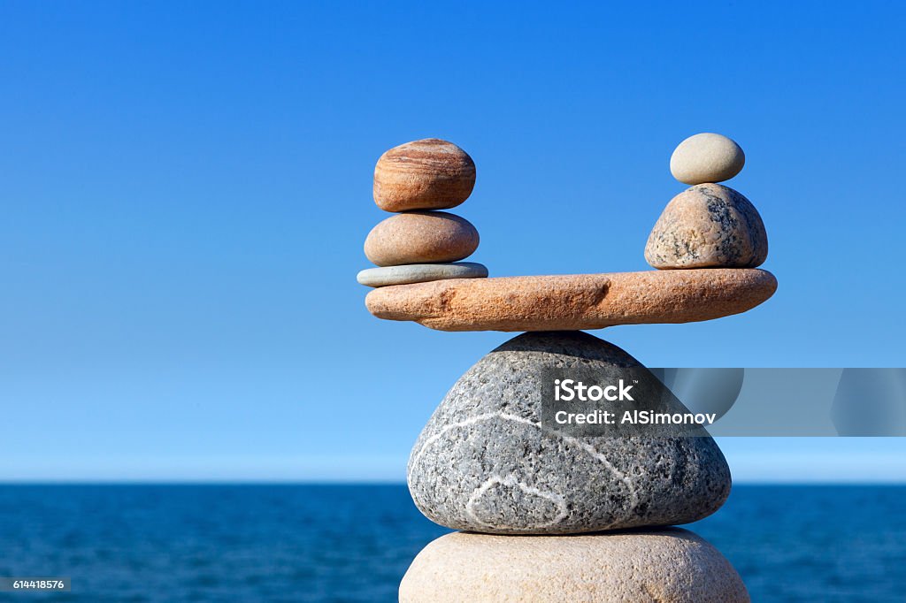 Concept of harmony and balance. Balance stones against the sea. Concept of harmony and balance. Balance stones against the sea. Rock zen in the form of scales Harmony Stock Photo