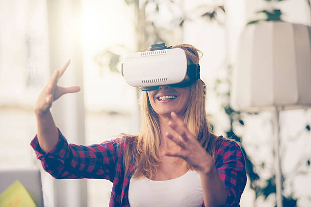 istock Amazed woman looking in a VR goggles and gesturing 614418918