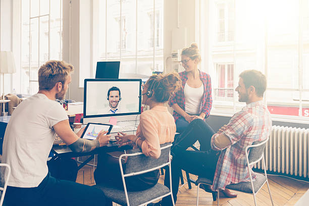 Coworkers doing a video conference in the conference room stock photo