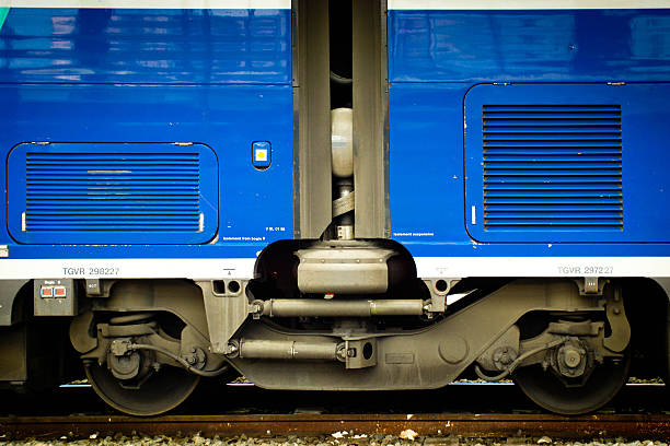Nice, France - July 30, 2015: The railway platform at Nice station with a TGV train at the plarform, this is aclose up of the coupling and the wheels and bogie under the train.
