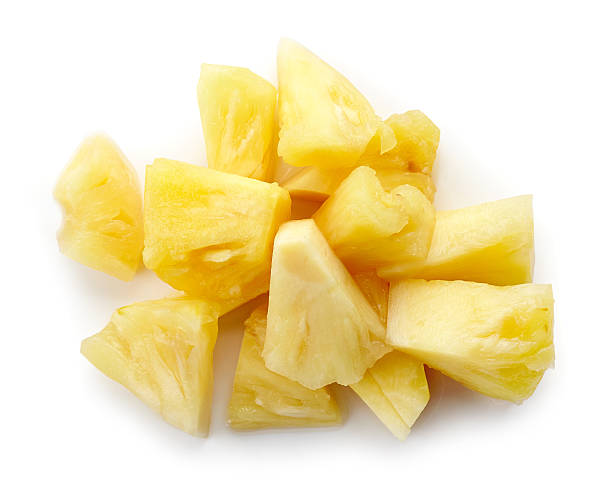 istock Canned pineapple chunks isolated on white, from above 614421914