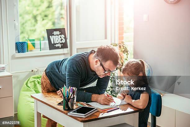 Father Helping Daughter To Finish Homework Stock Photo - Download Image Now - Father, Homework, Assistance