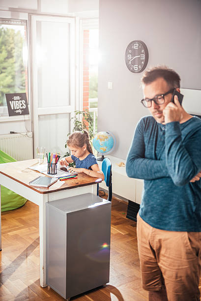 istock Daughter doing homework with father in her room 614422630