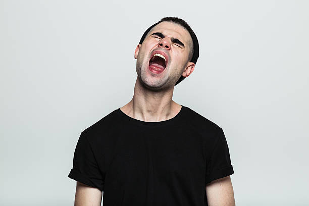 istock Screaming man in black t-shirt 614423840