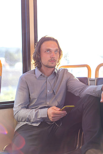 istock Young adult male commuting to work using public transit 614424622