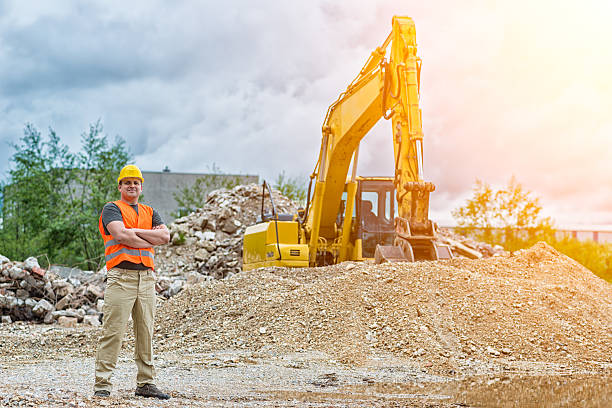 istock Portrait of an Earth Digger Driver with blueprint in hand 614424766