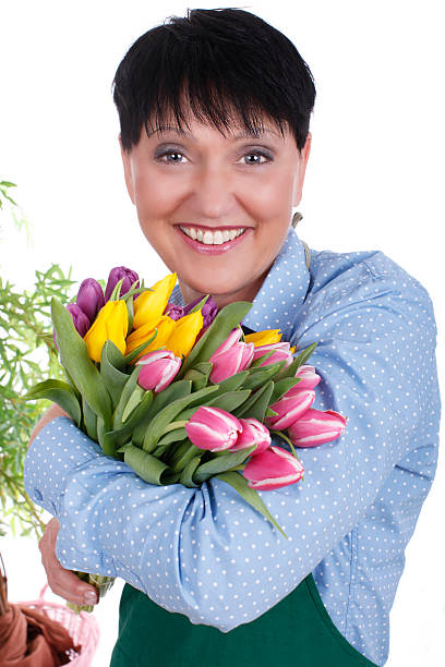 istock Happy senior woman with tulips 614425006
