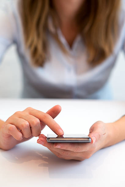 istock Young adult using smartphone in the office 614426214