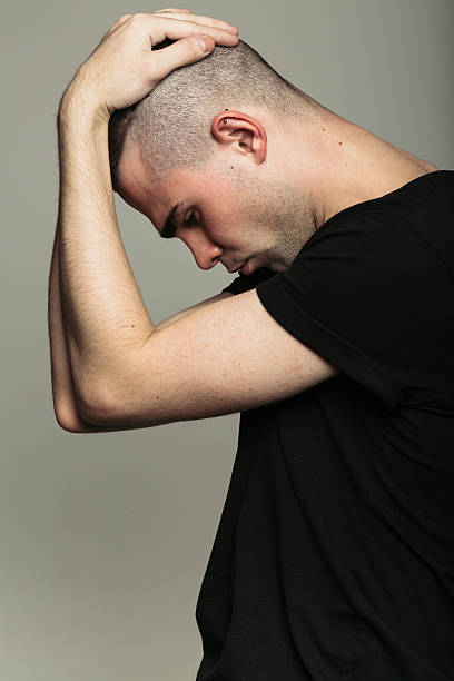 istock Man in black t-shirt with both hands on his 614426544