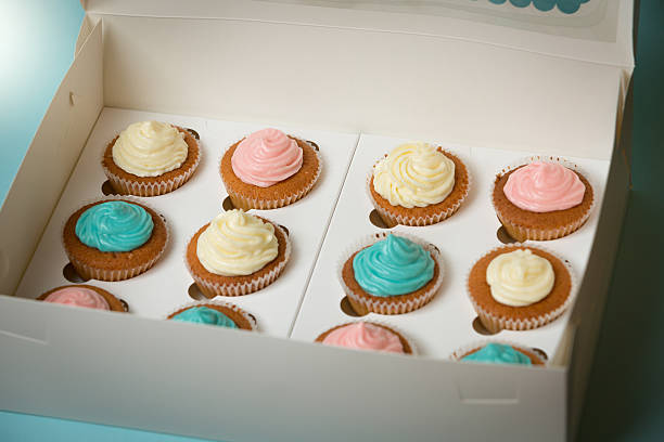 istock Colorful cupcakes with buttercream in open paper box 614426590