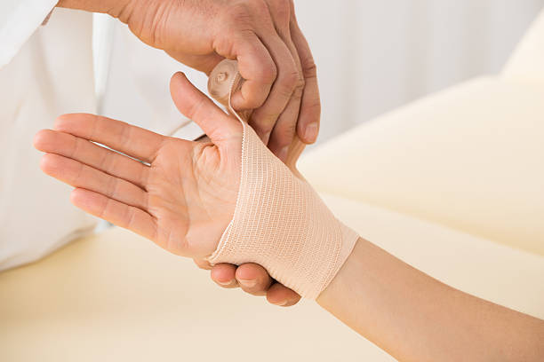 istock Doctor Wrapping Elastic Bandage To Patient 614426666