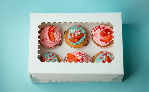 istock Six colorful cupcakes decorated with sprinkles and strawberries 614426848