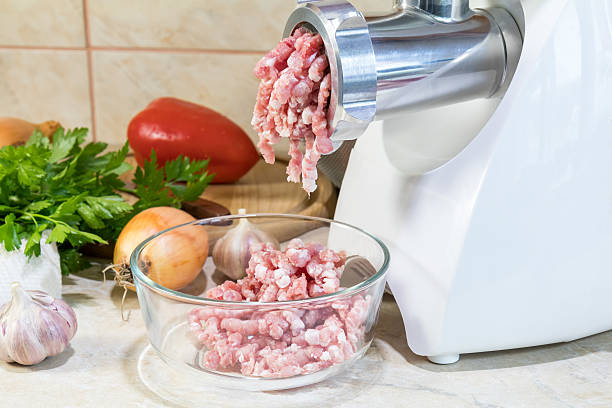 istock Home electric meat-grinder is making pork stuffing 614427836