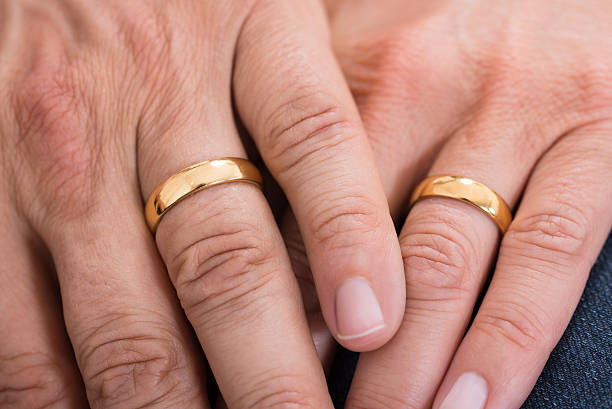Close-up Of Hands With Rings Close-up Of Hands With Golden Wedding Rings 50th anniversary photos stock pictures, royalty-free photos & images