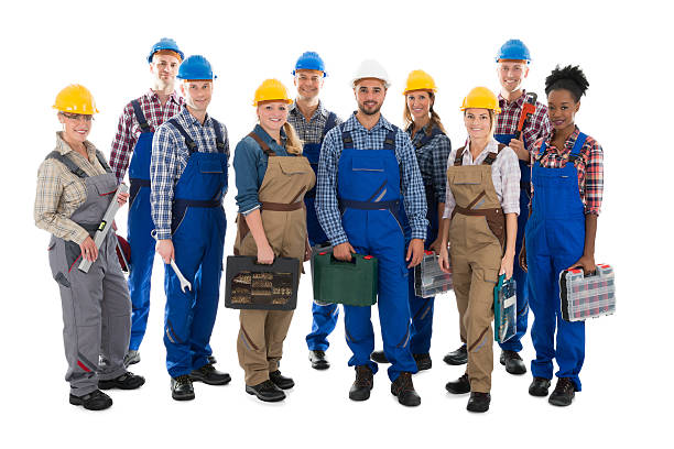 istock Portrait Of Confident Carpenters Carrying Toolboxes 614430366