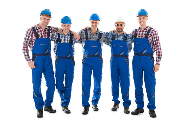 confident male carpenters standing with arms around - manual worker full length isolated on white standing imagens e fotografias de stock